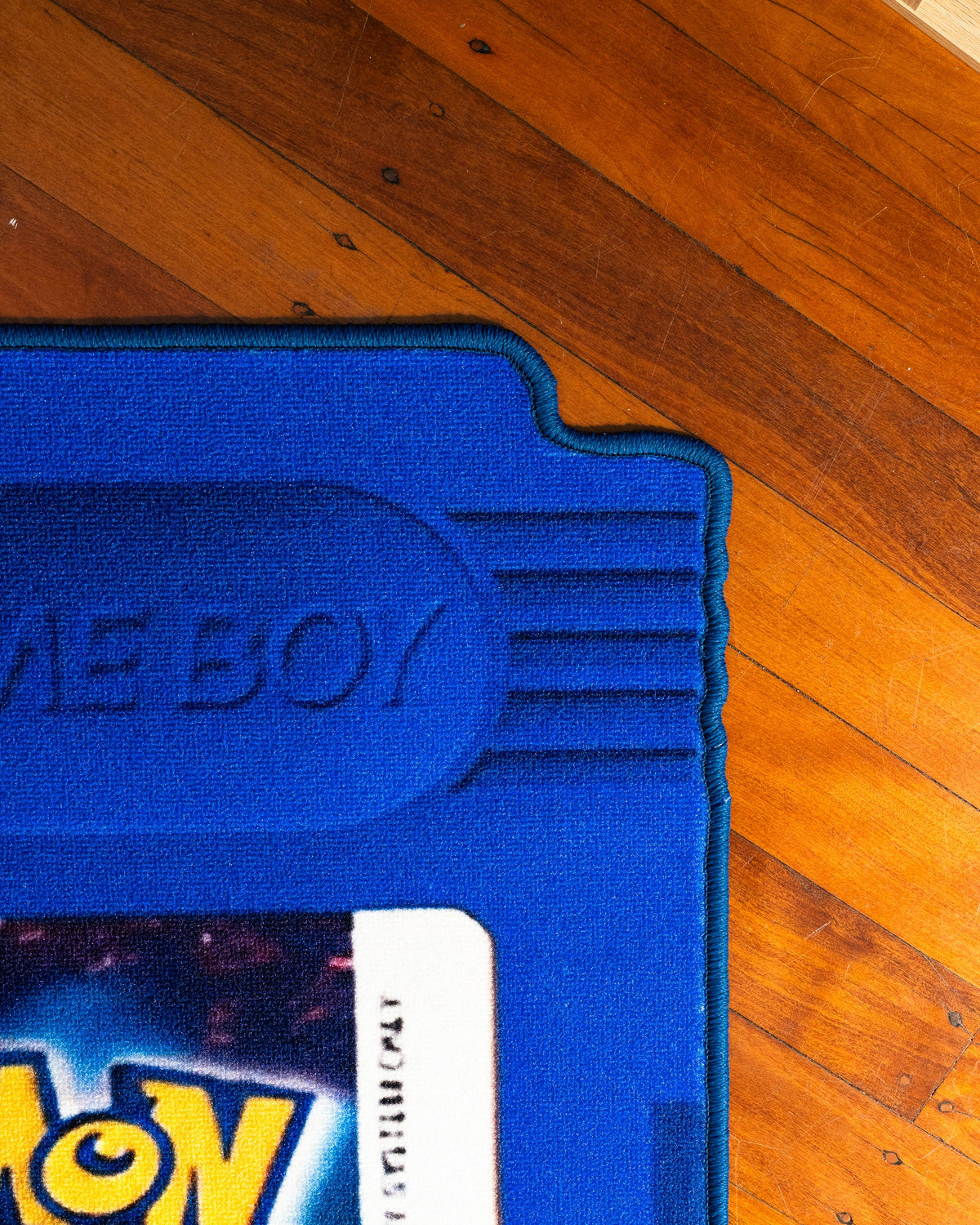 Pokemon Blue cartridge cut-out rug full view showing the shaped edge