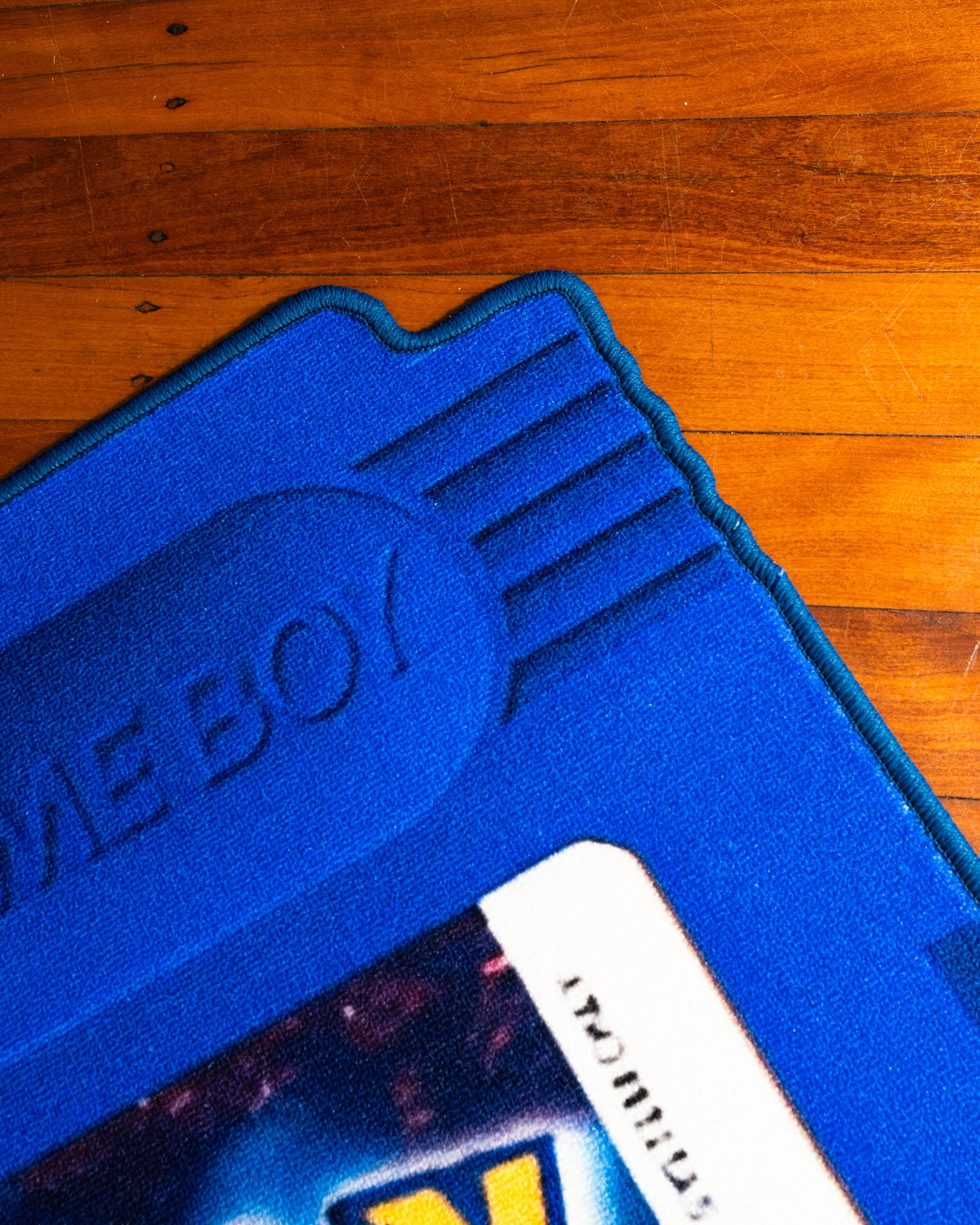 Pokemon Blue cartridge cut-out rug shown for scale in a room