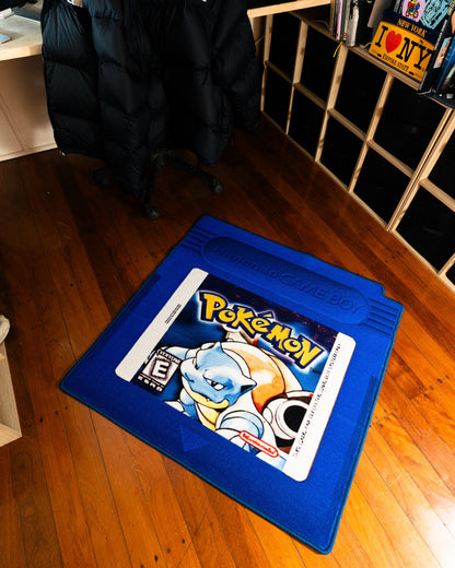 Pokemon Blue cartridge cut-out rug in a bedroom