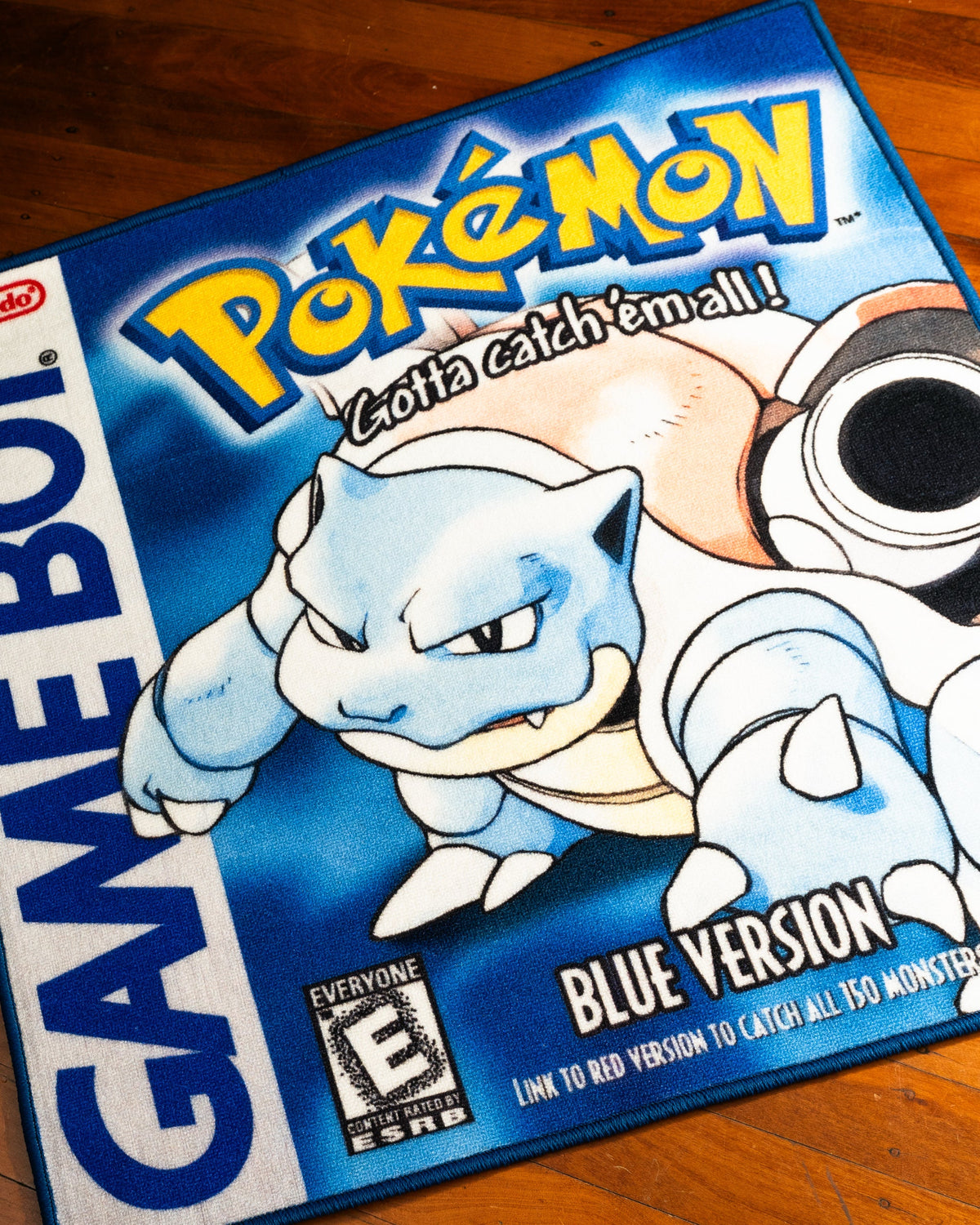 Pokemon Blue box art rug shown for scale in a room