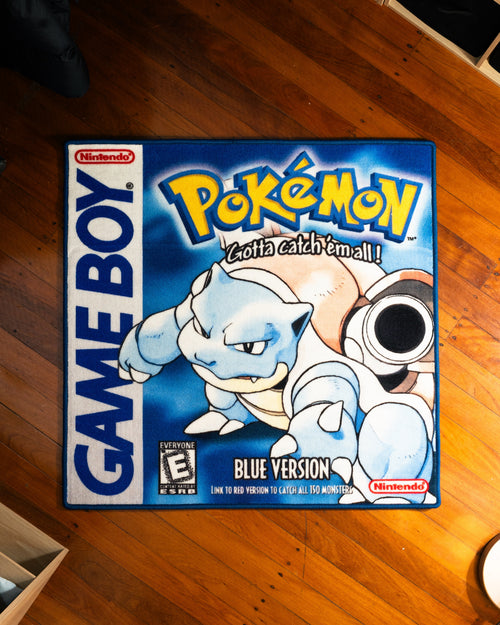 Pokemon Blue box art rug laid out on a floor