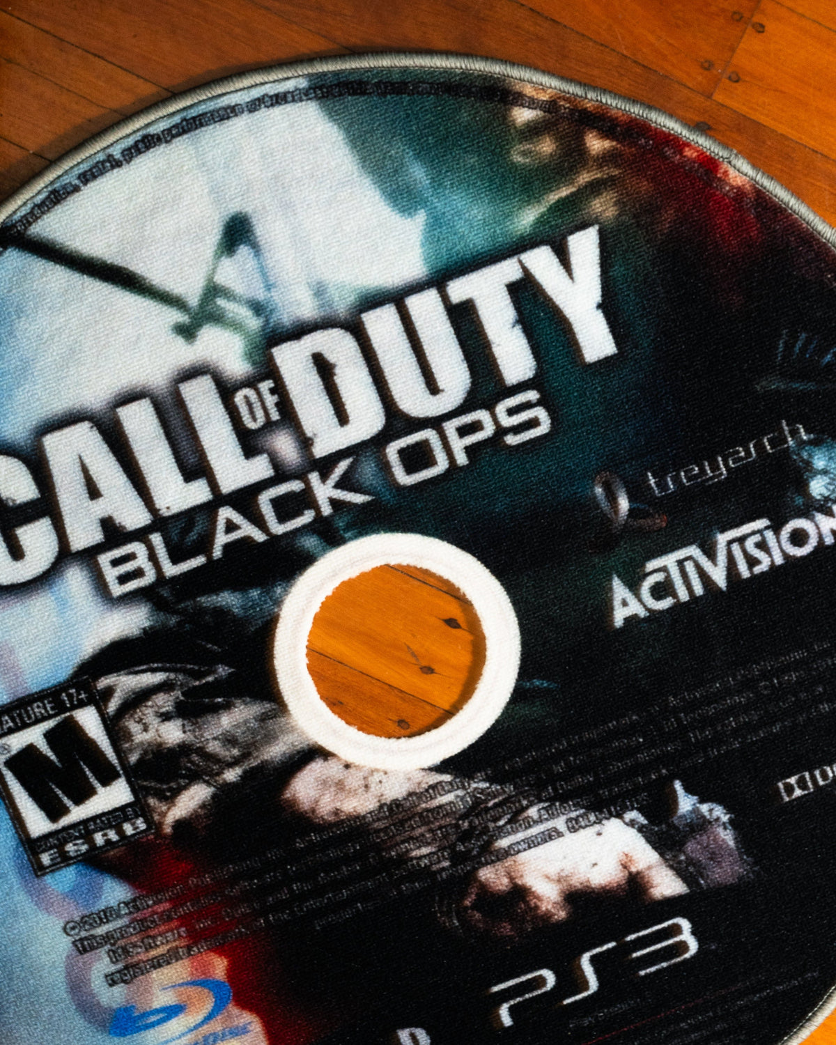 Black Ops disc rug shown for scale in a room