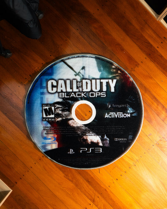 Black Ops disc rug laid out on a floor