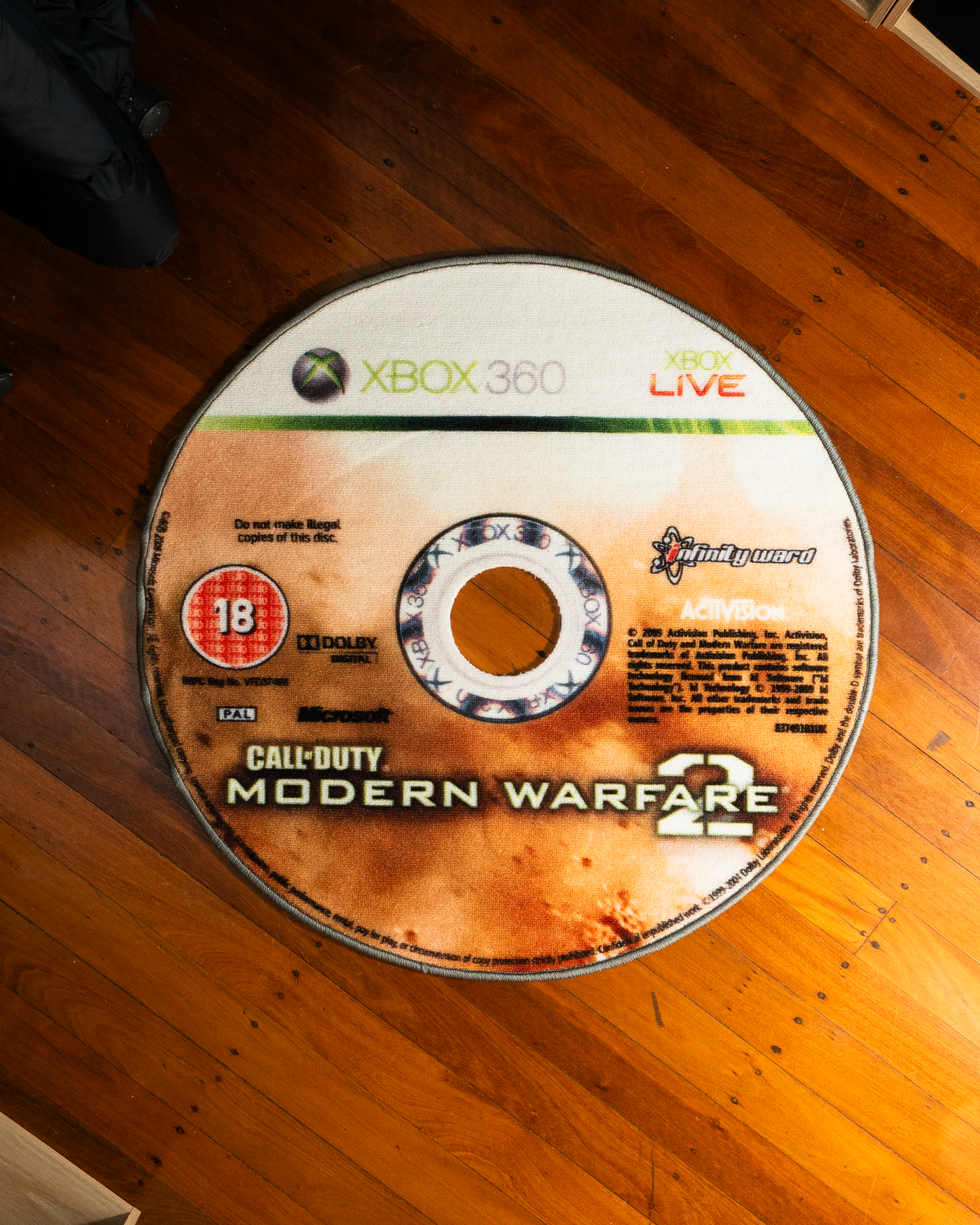 Modern Warfare 2 disc rug laid out on a floor