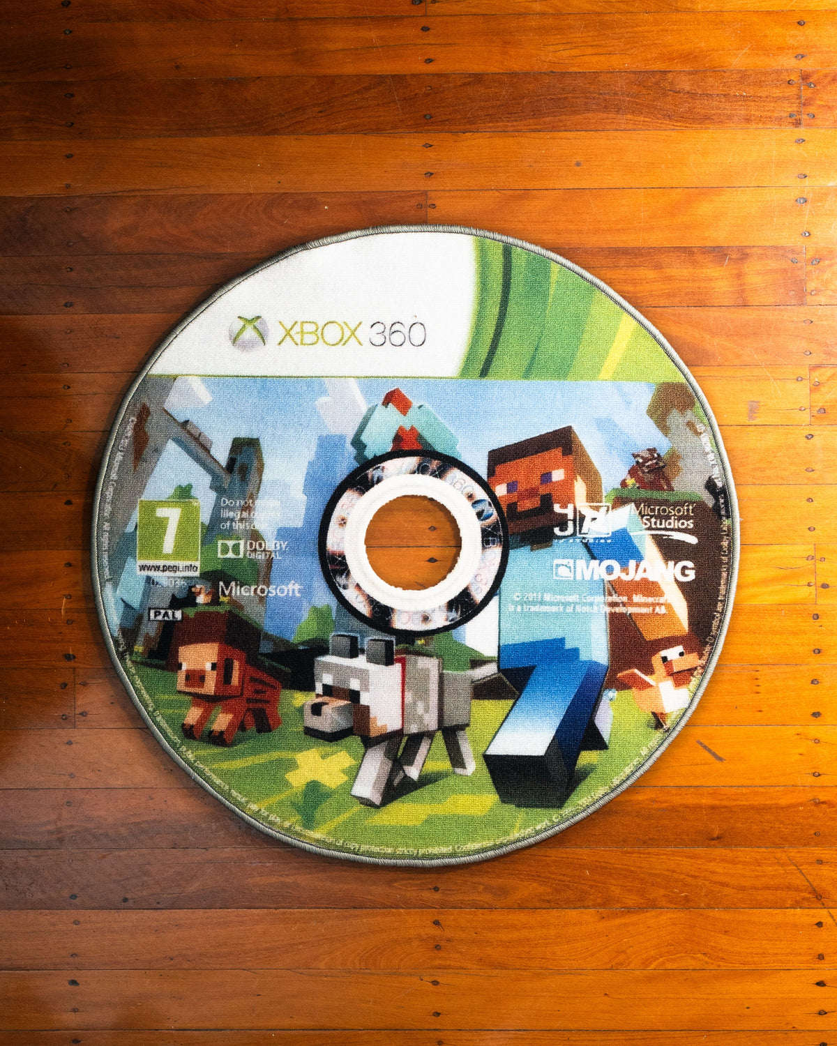 Minecraft Xbox 360 disc rug laid out on a floor
