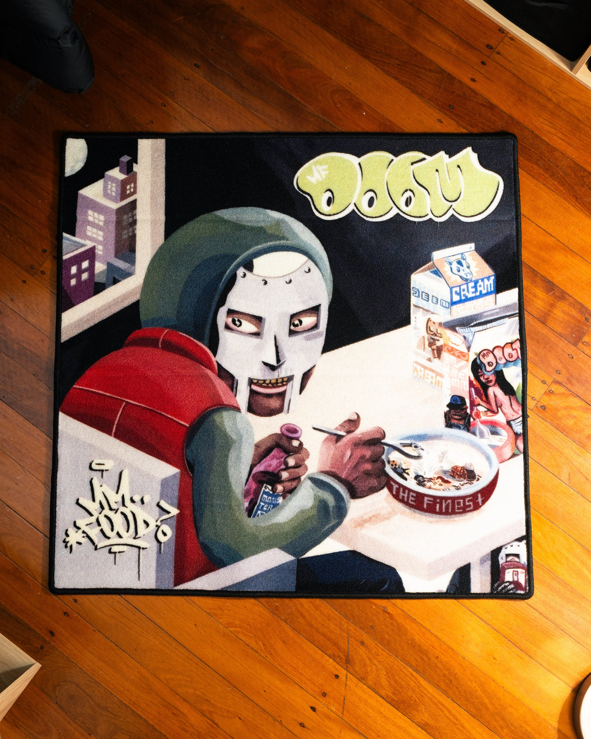 MF DOOM MM FOOD album rug laid out on a floor
