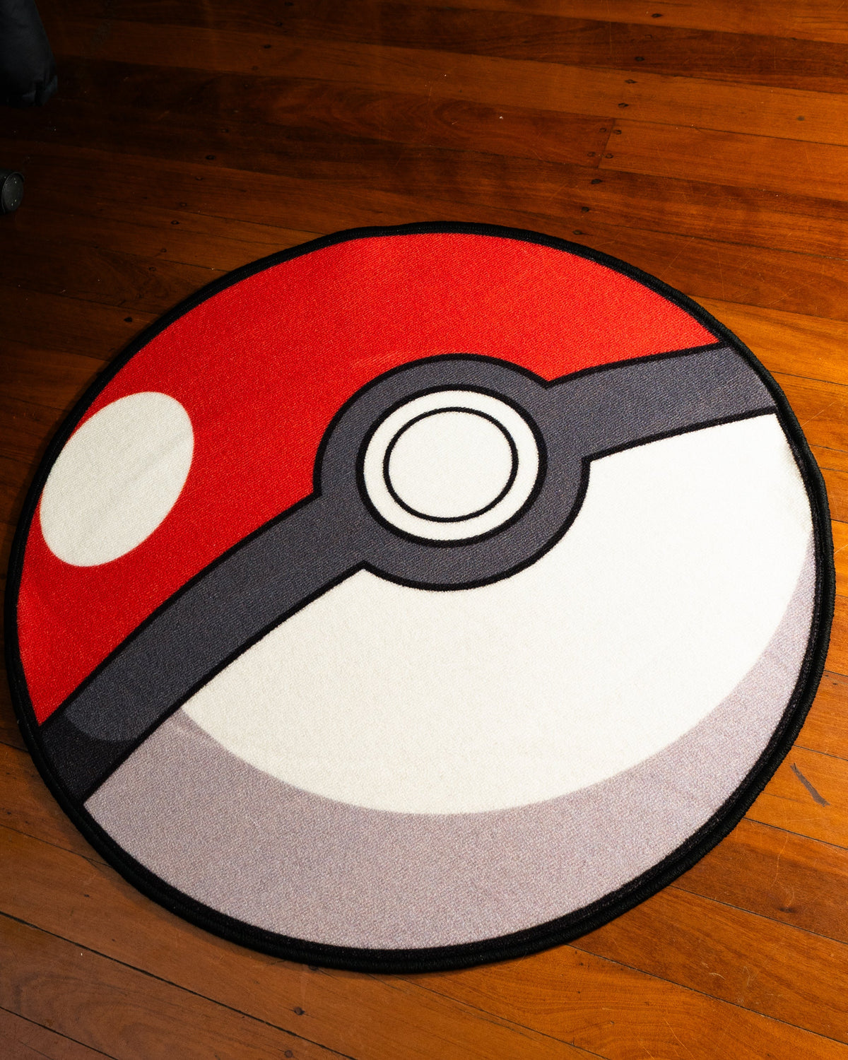Poke Ball round rug shown for scale in a room