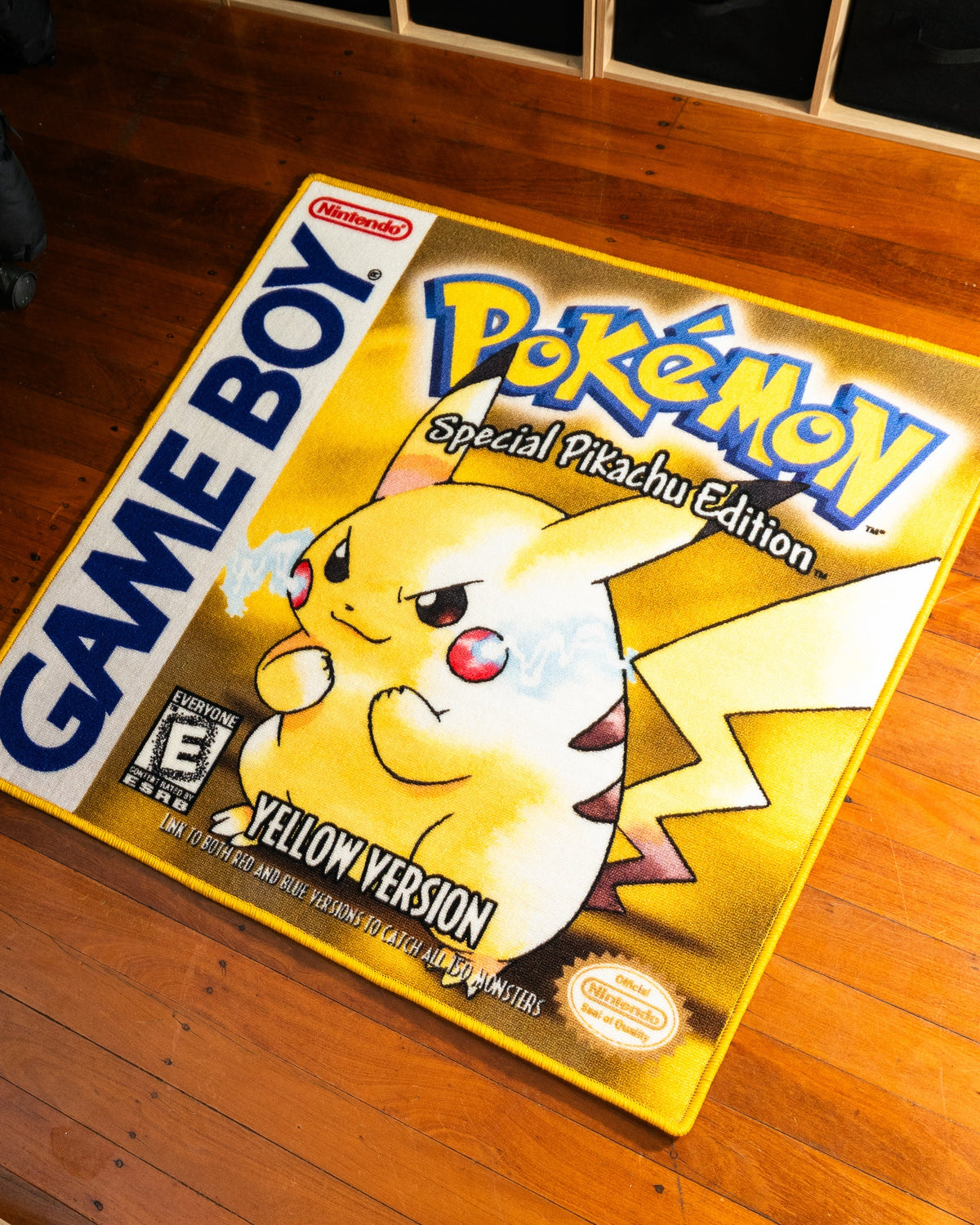 Pokemon Yellow box art rug shown for scale in a room