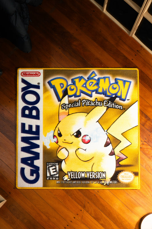 Pokemon Yellow box art rug laid out on a floor