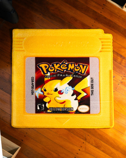 Pokemon Yellow cartridge cut-out rug on a wooden floor