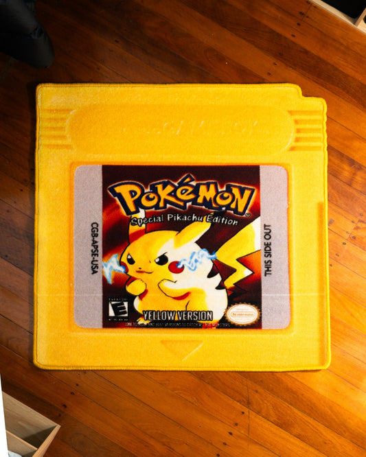 Pokemon Yellow cartridge cut-out rug on a wooden floor